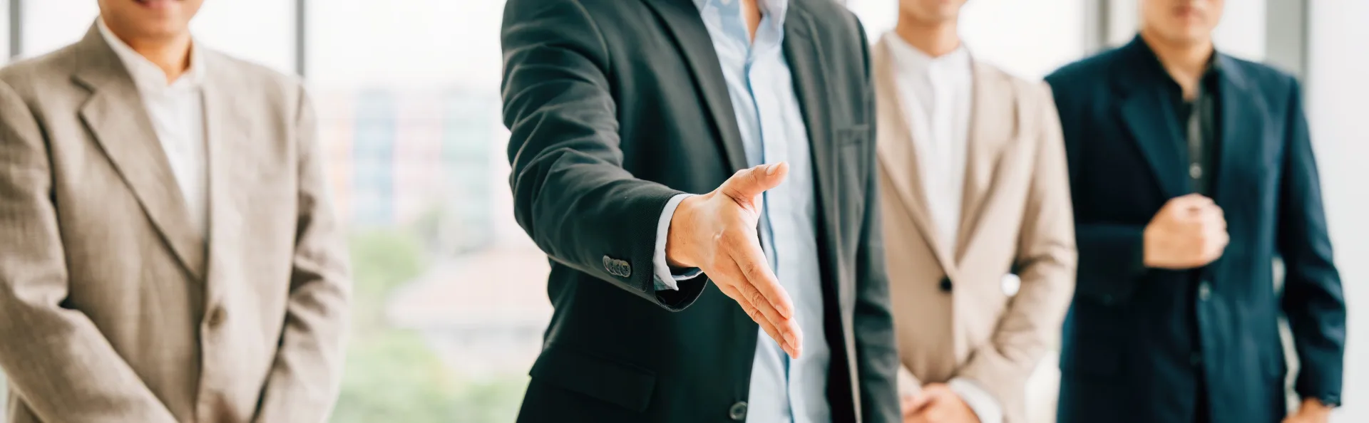 Double exposure of business people shaking hands with modern city skyline representing partnership, corporate teamwork and global financial deals